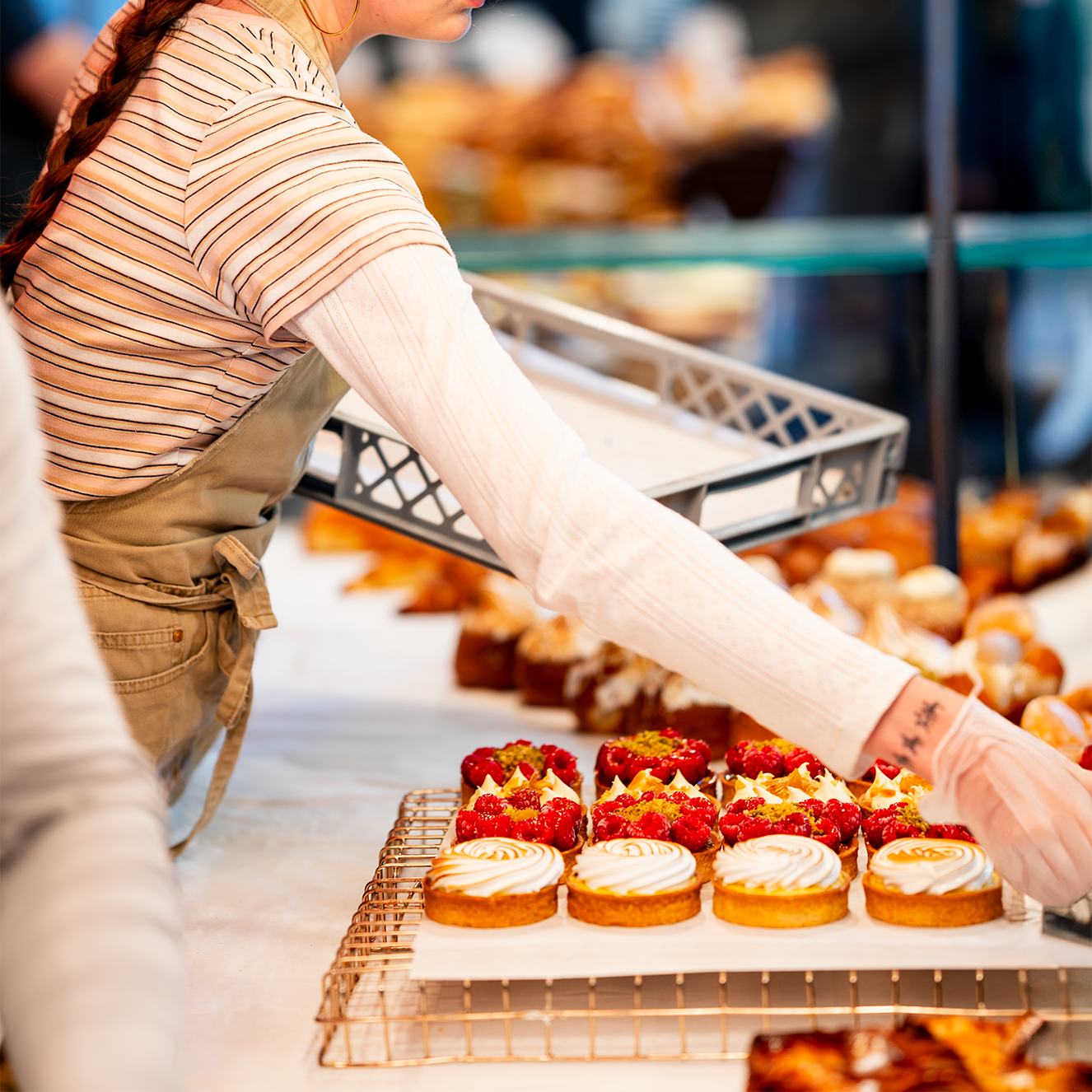 Comptoir Bakery staff setting up at the market, adding delicious pastries and the final touches before opening.