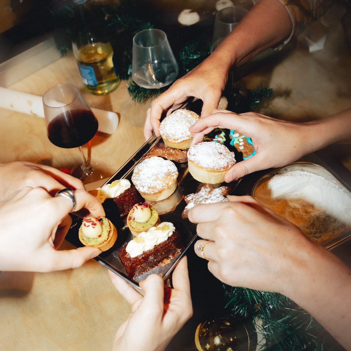 people taking bakery items from tray in Christmas party in London