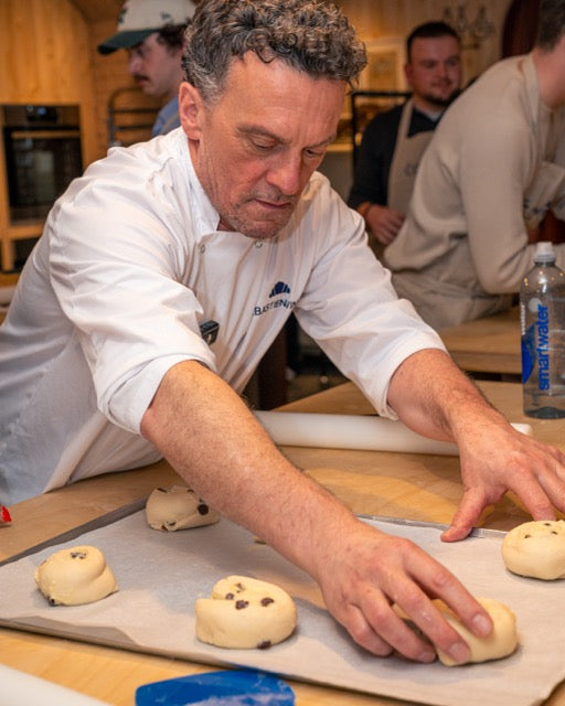 chef helping bakery school class with pastries